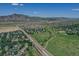 Scenic aerial shot features a neighborhood with a backdrop of rolling hills and lush green space for recreation at 14191 W Amherst Ave, Lakewood, CO 80228