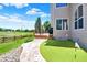 Backyard view featuring a manicured lawn, putting green, and wood deck perfect for outdoor entertaining at 14191 W Amherst Ave, Lakewood, CO 80228