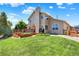 Expansive backyard view highlighting the home's well-maintained lawn and inviting outdoor deck area at 14191 W Amherst Ave, Lakewood, CO 80228