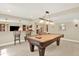 Spacious basement featuring a pool table, bar seating, and recessed lighting for entertaining guests at 14191 W Amherst Ave, Lakewood, CO 80228