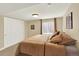 Comfortable bedroom with carpet, a double door closet, warm walls, and window for natural light at 14191 W Amherst Ave, Lakewood, CO 80228