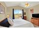 Comfortable bedroom with vaulted ceiling, large window overlooking the yard, and cozy decor at 14191 W Amherst Ave, Lakewood, CO 80228