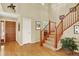 Bright foyer featuring hardwood floors, a staircase, and soaring ceilings at 14191 W Amherst Ave, Lakewood, CO 80228