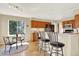 Bright kitchen with light wood cabinets, stainless steel appliances, and breakfast bar seating at 14191 W Amherst Ave, Lakewood, CO 80228