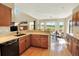 Spacious kitchen with ample counter space, black appliances, and access to a deck with scenic views at 14191 W Amherst Ave, Lakewood, CO 80228