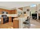 Open kitchen with breakfast bar overlooking the living room and fireplace, great for entertaining at 14191 W Amherst Ave, Lakewood, CO 80228
