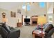 Bright living room with a fireplace, high ceilings, and comfortable seating at 14191 W Amherst Ave, Lakewood, CO 80228