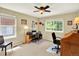 Functional home office with neutral carpet, a large window for natural light, and space for two desks at 14191 W Amherst Ave, Lakewood, CO 80228