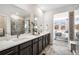 Gorgeous bathroom with a dual sink vanity and a glass enclosed shower at 3441 N Denali St, Aurora, CO 80019