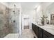 Bathroom featuring a glass enclosed shower, dual sink vanity, quartz counters, and gray tiled floors at 3441 N Denali St, Aurora, CO 80019