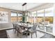 Bright dining room featuring a wooden table, woven chairs, and sliding glass doors to the outdoor patio at 3441 N Denali St, Aurora, CO 80019