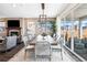 Dining room area with table, chairs, fireplace, and view to the exterior at 3441 N Denali St, Aurora, CO 80019