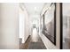 Bright hallway with hardwood floors, large mirrors, and modern wall art at 3441 N Denali St, Aurora, CO 80019