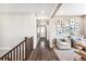 View of the entry from the upstairs hallway with hardwood floors and white trim at 3441 N Denali St, Aurora, CO 80019