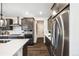 Sleek kitchen with stainless steel appliances and white countertops at 3441 N Denali St, Aurora, CO 80019