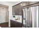 Kitchen featuring stainless steel refrigerator, dark wood cabinets, and white countertops at 3441 N Denali St, Aurora, CO 80019