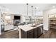 Open concept kitchen with island seating and view into living room at 3441 N Denali St, Aurora, CO 80019