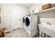 Convenient laundry room with washer, dryer, and utility sink at 3441 N Denali St, Aurora, CO 80019