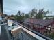 Balcony view with outdoor seating, overlooking neighborhood rooftops and tree tops at 1647 N Osceola St, Denver, CO 80204