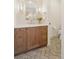 This bathroom boasts a wood vanity, herringbone floors, and modern fixtures at 1647 N Osceola St, Denver, CO 80204