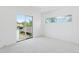 Bright bedroom with sliding glass doors and transom windows with views of the trees and neighborhood at 1647 N Osceola St, Denver, CO 80204