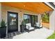 Inviting front porch with stylish seating, black accents, and a welcoming entrance at 1647 N Osceola St, Denver, CO 80204