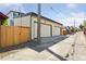 Detached two-car garage with secure backyard access via wooden gate at 1647 N Osceola St, Denver, CO 80204