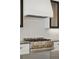 Close up of stainless steel gas range with sleek black cabinets and white backsplash at 1647 N Osceola St, Denver, CO 80204