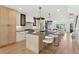 Open concept kitchen with large island and seating, stainless steel appliances, and modern design at 1647 N Osceola St, Denver, CO 80204