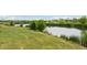 Green grass meets a serene lakeside on a sunny day at 1647 N Osceola St, Denver, CO 80204