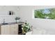 Living room with a wet bar, mini-fridge and view to exterior at 1647 N Osceola St, Denver, CO 80204