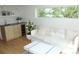 Bright living room featuring a modern couch, wet bar, and views of the outside at 1647 N Osceola St, Denver, CO 80204