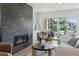 Cozy living room featuring a modern fireplace, stylish furniture, and plenty of natural light at 1647 N Osceola St, Denver, CO 80204