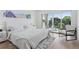 Serene main bedroom with large window, plush bedding, and access to outdoor space at 1647 N Osceola St, Denver, CO 80204