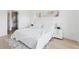 Bright main bedroom featuring a plush bed, minimalist decor, and lots of natural light at 1647 N Osceola St, Denver, CO 80204