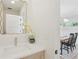 Stylish powder room featuring a modern sink, quartz countertop, and decorative mirror at 1647 N Osceola St, Denver, CO 80204