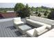 Comfortable outdoor seating with a sectional sofa and chair on a spacious rooftop deck with neighborhood views at 1647 N Osceola St, Denver, CO 80204