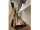 Unique lighting highlights this staircase with wood steps and sleek black railing at 1647 N Osceola St, Denver, CO 80204