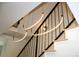 Modern staircase design featuring sleek black railings, floating wood treads, and contemporary hanging light fixtures at 1647 N Osceola St, Denver, CO 80204