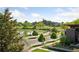 Scenic street view of lush green trees, sidewalk, and lake near the building at 1647 N Osceola St, Denver, CO 80204