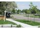 Sign displays 'Stunning Lake Views', and 'Expansive Roof Deck' near a home on a street with green grass and trees at 1647 N Osceola St, Denver, CO 80204
