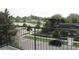 Scenic view from the balcony overlooking a pond, park, and city buildings at 1647 N Osceola St, Denver, CO 80204