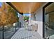 Open air balcony area featuring a sitting area with a glass panel railing to the outside at 1374 S Vine St, Denver, CO 80210