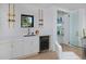 Bright bar area with white cabinets, wine cooler, and decorative wine rack display at 1374 S Vine St, Denver, CO 80210