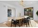 Modern dining room with a rustic wood table, black chairs, and contemporary light fixture at 1374 S Vine St, Denver, CO 80210