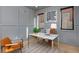 Stylish home office with gray walls, modern desk, and ample natural light from two windows at 1374 S Vine St, Denver, CO 80210