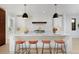 Bright, open kitchen with white countertops, pendant lighting, and seating for four at 1374 S Vine St, Denver, CO 80210