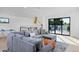 Spacious living room showcasing a sectional sofa and sliding glass doors to a rooftop deck at 1374 S Vine St, Denver, CO 80210