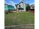 Spacious backyard featuring lush green grass, a sturdy wooden fence, and a playground area for endless outdoor fun at 4362 Denmark Ct, Denver, CO 80239