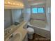 Bright bathroom featuring a large tub, a window, and a spacious sink and vanity at 4362 Denmark Ct, Denver, CO 80239